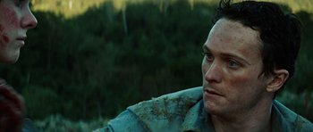 Movie still from “The Ruins” (2008), directed by Carter Smith – A person looking at the camera; Close Up shot, Over the shoulder angle