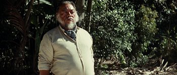 Movie still from “The Ruins” (2008), directed by Carter Smith – An old man with a beard and a tie; Close Up shot, Low angle
