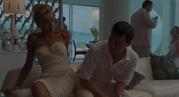 Movie still from “The Rum Diary” (2011), directed by Bruce Robinson – A man and a woman sitting on top of a bed; Medium shot, High angle