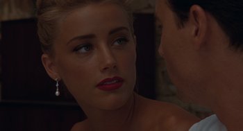 Movie still from “The Rum Diary” (2011), directed by Bruce Robinson – A beautiful blonde woman looking at a man in a suit; Close Up shot, Over the shoulder angle