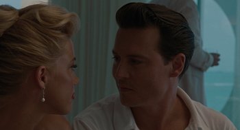 Movie still from “The Rum Diary” (2011), directed by Bruce Robinson – A man and a woman looking at one another; Close Up shot, Over the shoulder angle