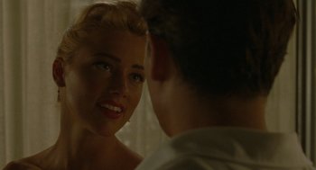 Movie still from “The Rum Diary” (2011), directed by Bruce Robinson – A man and a woman looking at one another in a mirror; Close Up shot, Over the shoulder angle