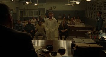 Movie still from “The Rum Diary” (2011), directed by Bruce Robinson – A group of people sitting in front of a table; Wide shot, High angle