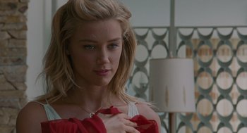 Movie still from “The Rum Diary” (2011), directed by Bruce Robinson – A beautiful young blond haired woman wearing a red top; Close Up shot, Over the shoulder angle
