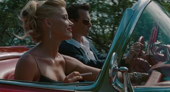 Movie still from “The Rum Diary” (2011), directed by Bruce Robinson – A man and a woman driving a car in the road; Close Up shot, Low angle