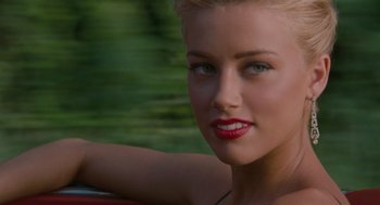Movie still from “The Rum Diary” (2011), directed by Bruce Robinson – A woman with red lipstick sitting in the back of a car; Close Up shot, Over the shoulder angle