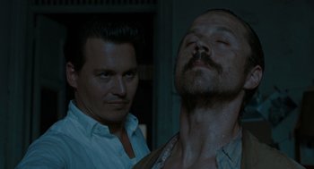Movie still from “The Rum Diary” (2011), directed by Bruce Robinson – A man with a beard and mustache and a man with a beard and mustache; Close Up shot, Low angle