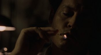 Movie still from “The Rum Diary” (2011), directed by Bruce Robinson – A man is smoking a cigarette in the dark; Close Up shot, Low angle