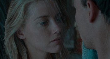 Movie still from “The Rum Diary” (2011), directed by Bruce Robinson – A young woman looking out of a window at a man; Close Up shot, Over the shoulder angle