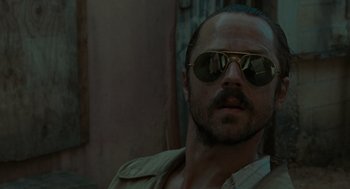 Movie still from “The Rum Diary” (2011), directed by Bruce Robinson – A person wearing sunglasses; Close Up shot, Low angle
