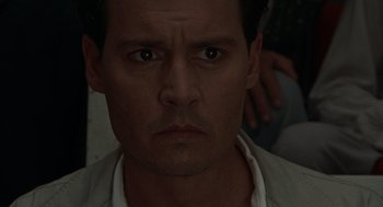 Movie still from “The Rum Diary” (2011), directed by Bruce Robinson – A man's face in a dark room; Close Up shot, High angle