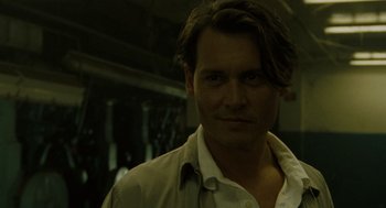Movie still from “The Rum Diary” (2011), directed by Bruce Robinson – A person wearing a white shirt; Close Up shot, Over the shoulder angle