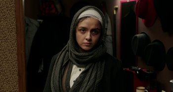 Movie still from “The Salesman” (2016), directed by Asghar Farhadi – A woman wearing a head scarf and a jacket; Close Up shot, Over the shoulder angle