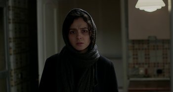 Movie still from “The Salesman” (2016), directed by Asghar Farhadi – A woman in a black coat and a scarf; Close Up shot, Over the shoulder angle