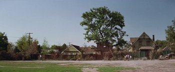 Movie still from “The Sandlot” (1993), directed by David Mickey Evans – An old house with a large tree in front of it; Extreme Wide shot, Low angle