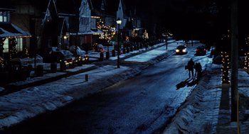 Movie still from “The Santa Clause” (1994), directed by John Pasquin – A car driving down a street at night; Extreme Wide shot, High angle