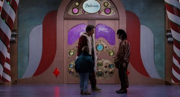 Movie still from “The Santa Clause” (1994), directed by John Pasquin – A group of people standing in front of a building; Wide shot, Low angle
