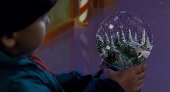 Movie still from “The Santa Clause” (1994), directed by John Pasquin – A person holding a snow globe in their hands; Extreme Close Up shot, High angle