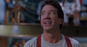 Movie still from “The Santa Clause” (1994), directed by John Pasquin – A person wearing a shirt and suspenders; Close Up shot, Low angle