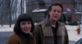 Movie still from “The Santa Clause” (1994), directed by John Pasquin – A man and a woman standing next to each other in front of a building; Close Up shot, Over the shoulder angle