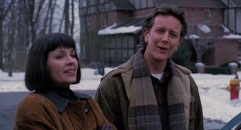 Movie still from “The Santa Clause” (1994), directed by John Pasquin – A man and a woman standing next to each other; Close Up shot, Over the shoulder angle