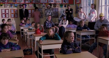 Movie still from “The Santa Clause” (1994), directed by John Pasquin – A group of children sitting at desks in a classroom; Wide shot, High angle