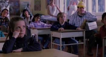 Movie still from “The Santa Clause” (1994), directed by John Pasquin – A group of people sitting at desks in a classroom; Medium shot, Over the shoulder angle