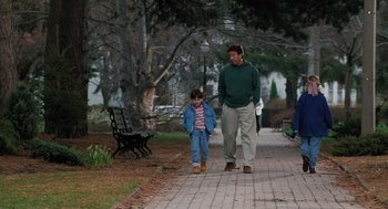 Movie still from “The Santa Clause” (1994), directed by John Pasquin – A man and a child walking down a sidewalk; Wide shot, High angle
