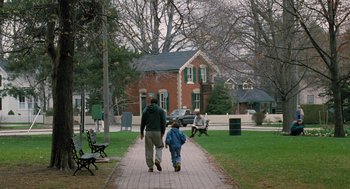 Movie still from “The Santa Clause” (1994), directed by John Pasquin – A man and a child walking down a sidewalk; Wide shot, Over the shoulder angle