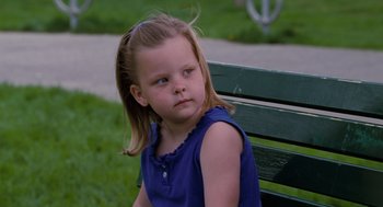 Movie still from “The Santa Clause” (1994), directed by John Pasquin – A little girl sitting on top of a park bench; Close Up shot, High angle