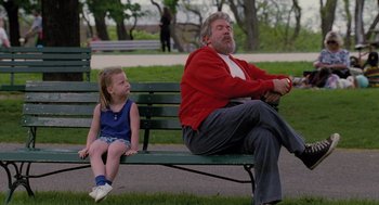 Movie still from “The Santa Clause” (1994), directed by John Pasquin – An older man sitting on top of a bench next to a little girl; Medium shot, Over the shoulder angle