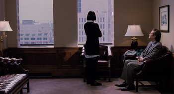 Movie still from “The Santa Clause” (1994), directed by John Pasquin – A woman sitting in front of a window in a room; Wide shot, Over the shoulder angle