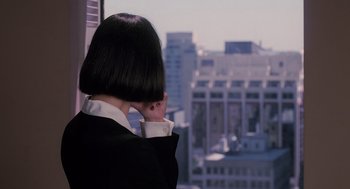 Movie still from “The Santa Clause” (1994), directed by John Pasquin – A woman with a short black hair looks out of a window; Close Up shot, Over the shoulder angle