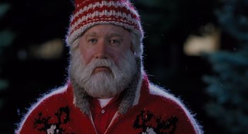 Movie still from “The Santa Clause” (1994), directed by John Pasquin – A person with a beard wearing a sweater; Close Up shot, Low angle