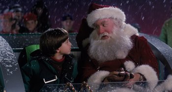 Movie still from “The Santa Clause” (1994), directed by John Pasquin – A man in a santa clause suit talking to a boy; Medium shot, Over the shoulder angle