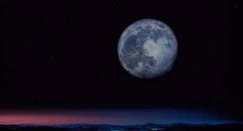 Movie still from “The Santa Clause” (1994), directed by John Pasquin – A full moon is seen in the night sky; Extreme Wide shot, Low angle
