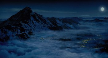 Movie still from “The Santa Clause” (1994), directed by John Pasquin – A view of a mountain at night from above the clouds; Extreme Wide shot, High angle
