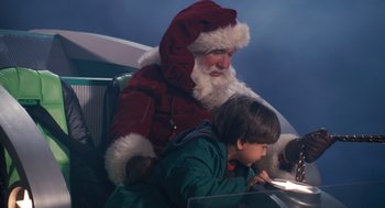 Movie still from “The Santa Clause” (1994), directed by John Pasquin – A man dressed as santa claus sitting next to a boy; Medium shot, Over the shoulder angle