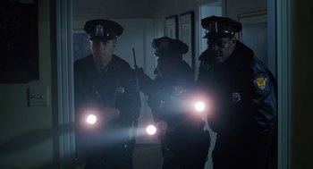 Movie still from “The Santa Clause” (1994), directed by John Pasquin – A group of police officers standing next to each other; Medium shot, Low angle