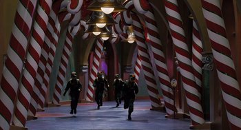 Movie still from “The Santa Clause” (1994), directed by John Pasquin – A group of people walking down a hall way; Extreme Wide shot, High angle