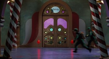 Movie still from “The Santa Clause” (1994), directed by John Pasquin – A person walking in front of an entrance to a building; Extreme Wide shot, Low angle