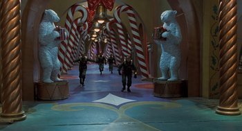 Movie still from “The Santa Clause” (1994), directed by John Pasquin – A group of people walking down a hall way; Extreme Wide shot, High angle