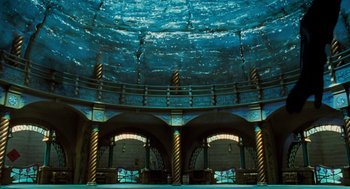 Movie still from “The Santa Clause” (1994), directed by John Pasquin – A view of the inside of a building with blue water; Extreme Wide shot, Low angle