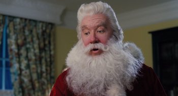 Movie still from “The Santa Clause” (1994), directed by John Pasquin – A person wearing a santa claus costume; Close Up shot, Over the shoulder angle