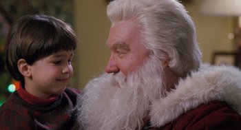 Movie still from “The Santa Clause” (1994), directed by John Pasquin – An old man with a long white beard and a young boy; Close Up shot, Over the shoulder angle