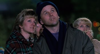 Movie still from “The Santa Clause” (1994), directed by John Pasquin – A man and a woman looking up at the sky; Close Up shot, Low angle