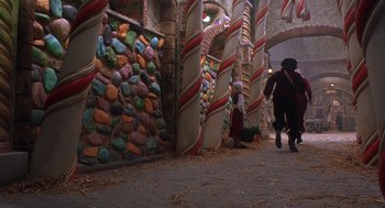 Movie still from “The Santa Clause 2” (2002), directed by Michael Lembeck – A man and a child walking down a path in front of a candy store; Extreme Wide shot, High angle