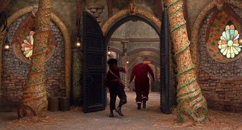 Movie still from “The Santa Clause 2” (2002), directed by Michael Lembeck – A couple of people that are walking in a tunnel; Wide shot, Low angle