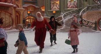 Movie still from “The Santa Clause 2” (2002), directed by Michael Lembeck – A man dressed as santa claus and a woman dressed as mrs; Wide shot, Low angle