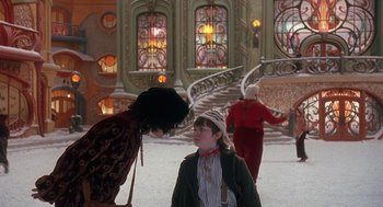 Movie still from “The Santa Clause 2” (2002), directed by Michael Lembeck – Two women and a child in a room with stained glass windows; Wide shot, Over the shoulder angle